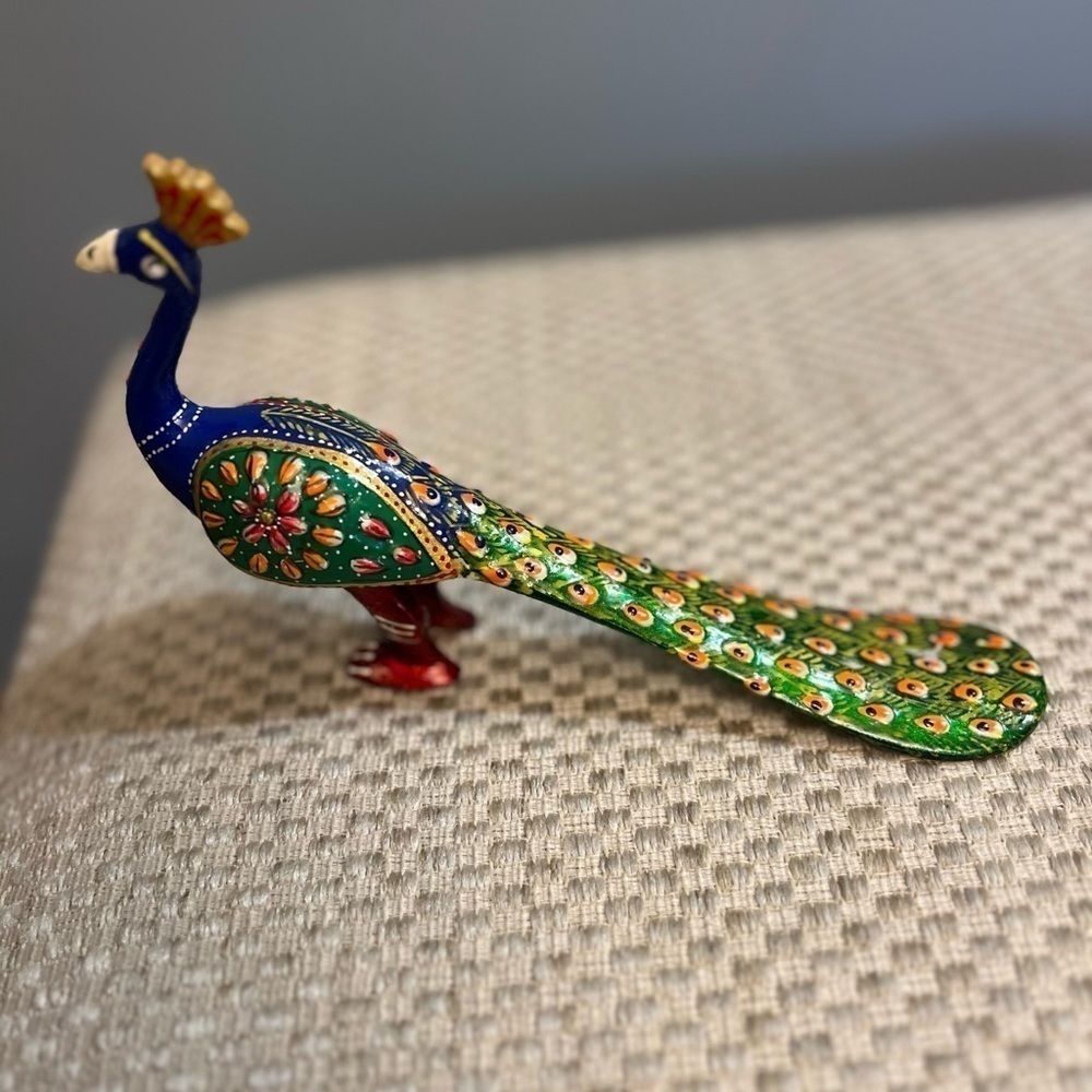 Hand-painted aluminum peacock sculpture from India.